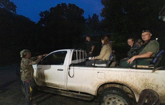 Group on a night drive vehicle with a spotter and driver