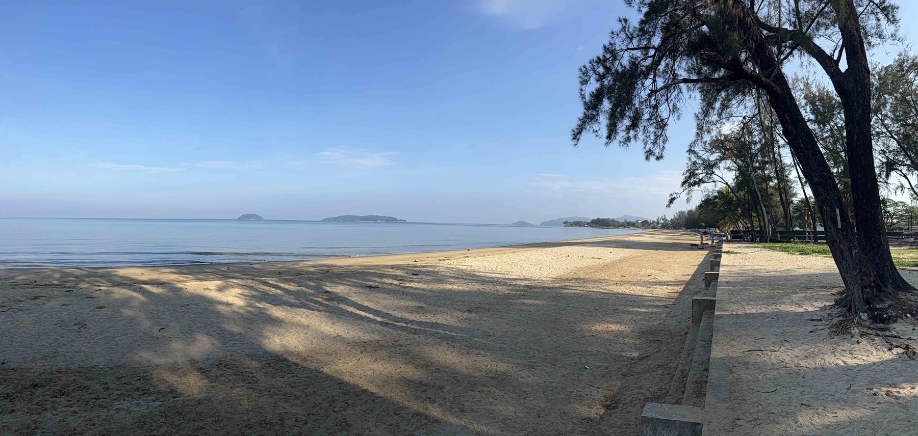Tanjung Aru Beach at Kota Kinabalu, with trees lining the shore