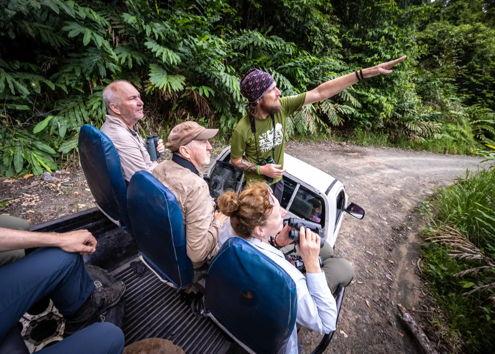 Mike Gordon spotting wildlife from the back of the truck during a Deramakot night drive